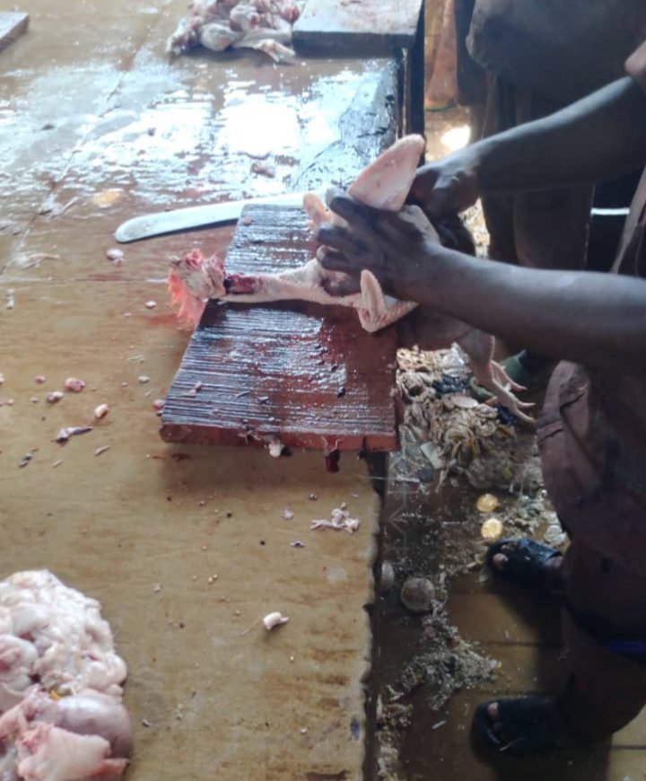 A butcher at work in an unhygienic environment